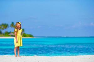 Adorable little girl at beach during summer vacation photo