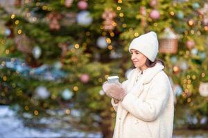 Smiling young girl skating on ice rink outdoors photo