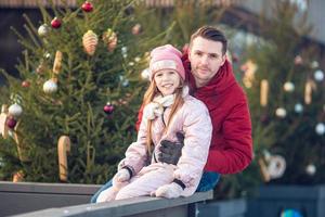 Family winter sport. Father and daughter on winter day photo