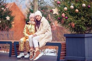 Family winter sport. Mother and daughter on winter day photo