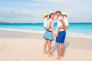 Photo of happy family having fun on the beach. Summer Lifestyle