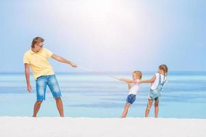 Happy beautiful family on a tropical beach vacation photo