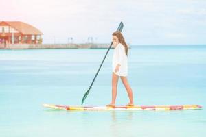 Woman surfing in the sea on vacation photo