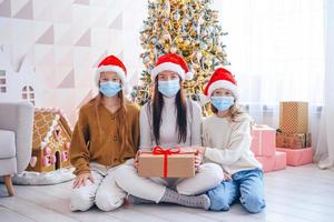 Young mom with kids holding christmas presents photo