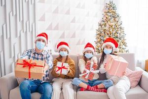 Happy young family with kids holding christmas presents photo