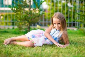 Adorable little girl happy outdoor at summer time photo