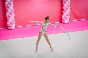 Little gymnast training on the carpet and ready for competitions photo