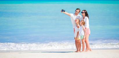 Panorama of happy beautiful family on the beach photo