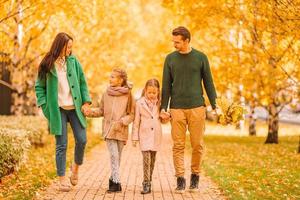 Portrait of happy family of four in autumn day photo