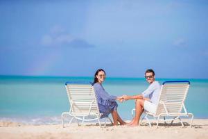 Couple relax on a tropical beach at Maldives photo
