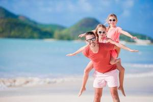 Father and kids enjoying beach summer vacation photo