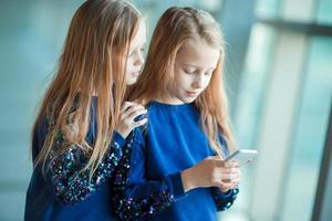 Little kids together in airport waiting for boarding photo