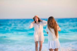 Beautiful mother and daughter on the beach photo