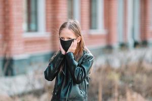 Girl wearing a mask on a background of a modern building, photo