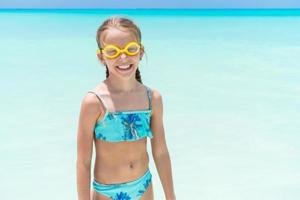 Cute little girl at beach during summer vacation photo