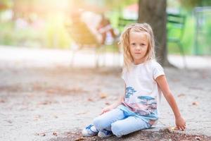 Adorable fashion little girl outdoors in the Tuileries Gardens, Paris photo