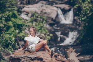 Little girl enjoying view of waterfall in Krasnay Poliana photo