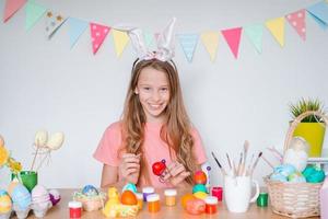Happy easter. Beautiful little kid wearing bunny ears on Easter day. photo