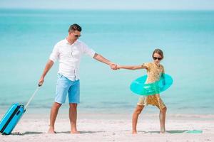 feliz padre y su adorable hijita en la playa tropical divirtiéndose foto