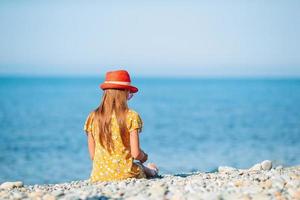 Cute little girl at beach during summer vacation photo