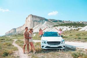 Parents and two little kids on summer car vacation photo