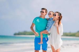 Young family on white beach during summer vacation photo