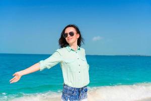 Young beautiful woman on tropical beach vacation photo