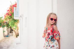 Girl in white dresses having fun outdoors on Mykonos streets photo