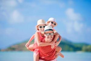 Father and kids on the beach photo