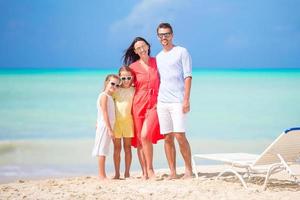 Happy beautiful family on the beach photo