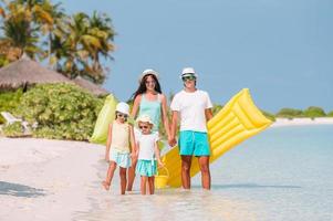 Happy family on a beach during summer vacation photo