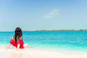 Young woman on a tropical beach with hat photo