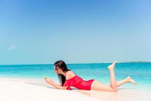 Young woman on a tropical beach with hat photo