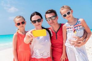 Young beautiful family taking selfie on the beach photo