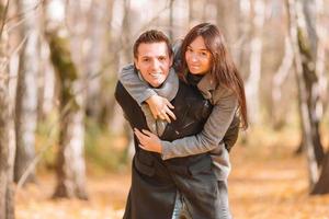 Happy family walking in autumn park on sunny fall day photo