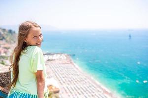 Young girl in background of mediterranean sea and sky. photo