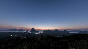 The morning sunrise, the sun shines through the thin clouds. At the beautiful mountain shape, Samet Nang Phang Nga, Thailand video