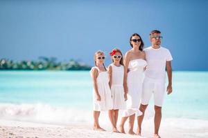 Happy beautiful family with kids on the beach photo