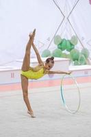 Little gymnast training on the carpet and ready for competitions photo