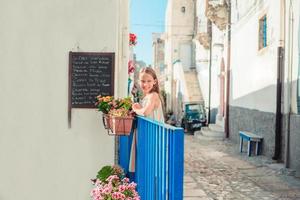 Adorable little girl in european city outdoors photo