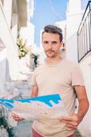 Man tourist with a city map outdoors photo