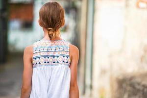 Adorable little girl in european city outdoors photo