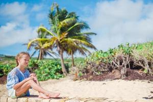 Portrait of adorable little girl at beach on her summer vacation photo