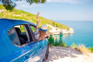 Little girl on vacation travel by car background beautiful landscape photo