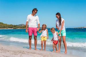 Happy beautiful family with kids on the beach photo