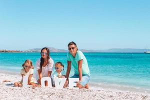 Happy beautiful family with kids on the beach photo