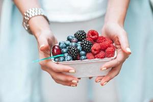 Closeup hands holding fresh berries photo