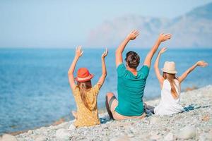 Happy beautiful family on a tropical beach vacation photo