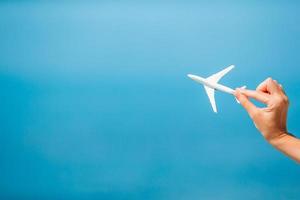 Miniature toy airplane in female hands. Trip by airplane. Conceptual image for travel and tourism. photo