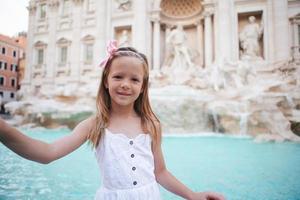 Adorable little girl background Trevi Fountain, Rome, Italy. photo